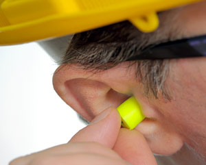 Disposable earplug in workers ear